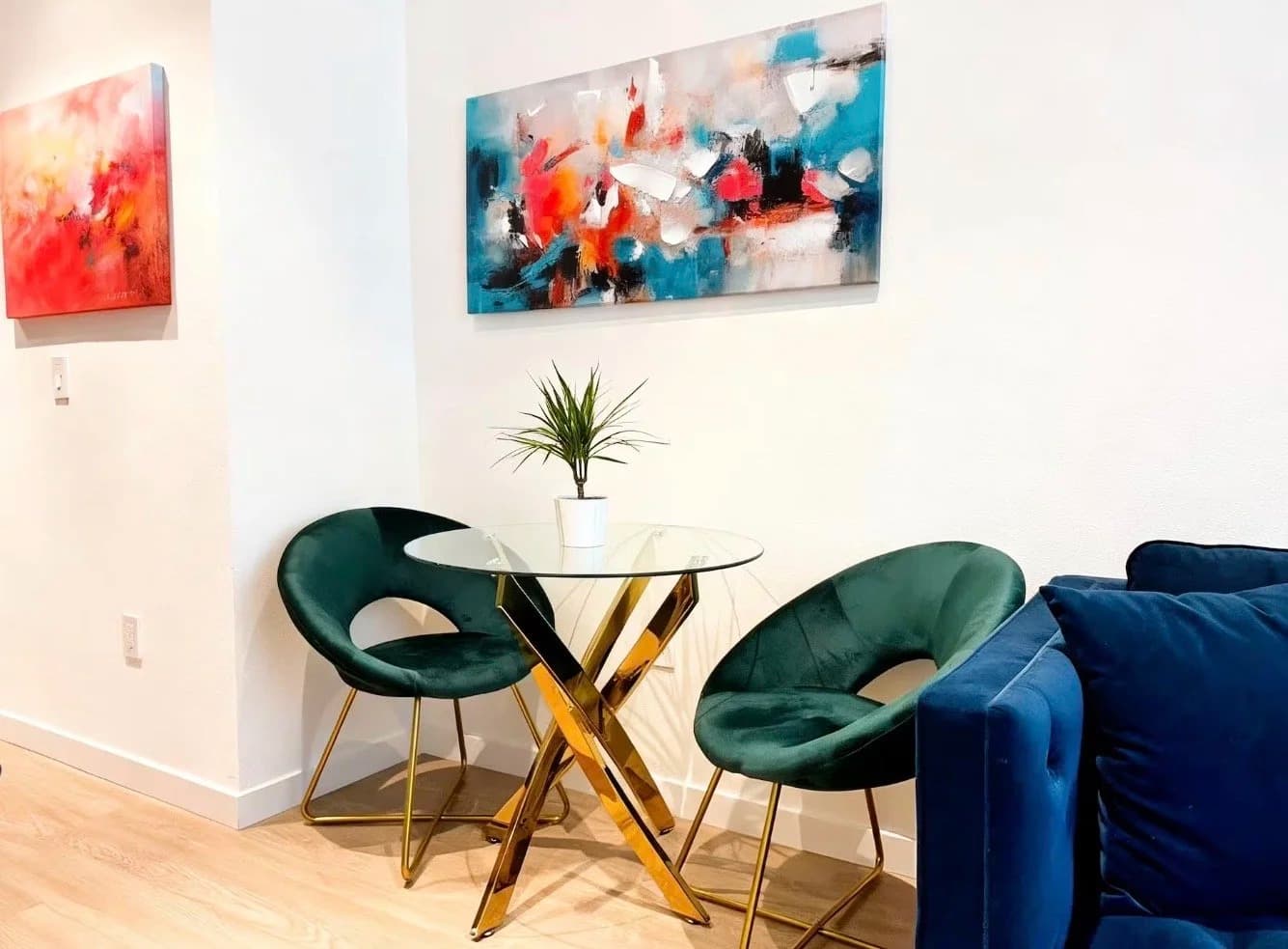 Furnished dining area with a glass table and velvet chairs in a Santa Monica monthly rental